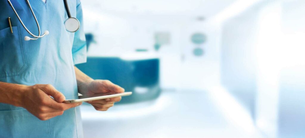 Zdjęcie lekarza monitorującego zdalnie stan pacjenta na tablecie