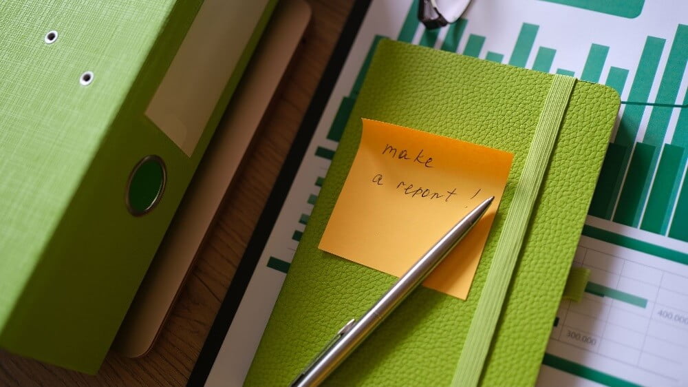a notebook with a sticky note saying 